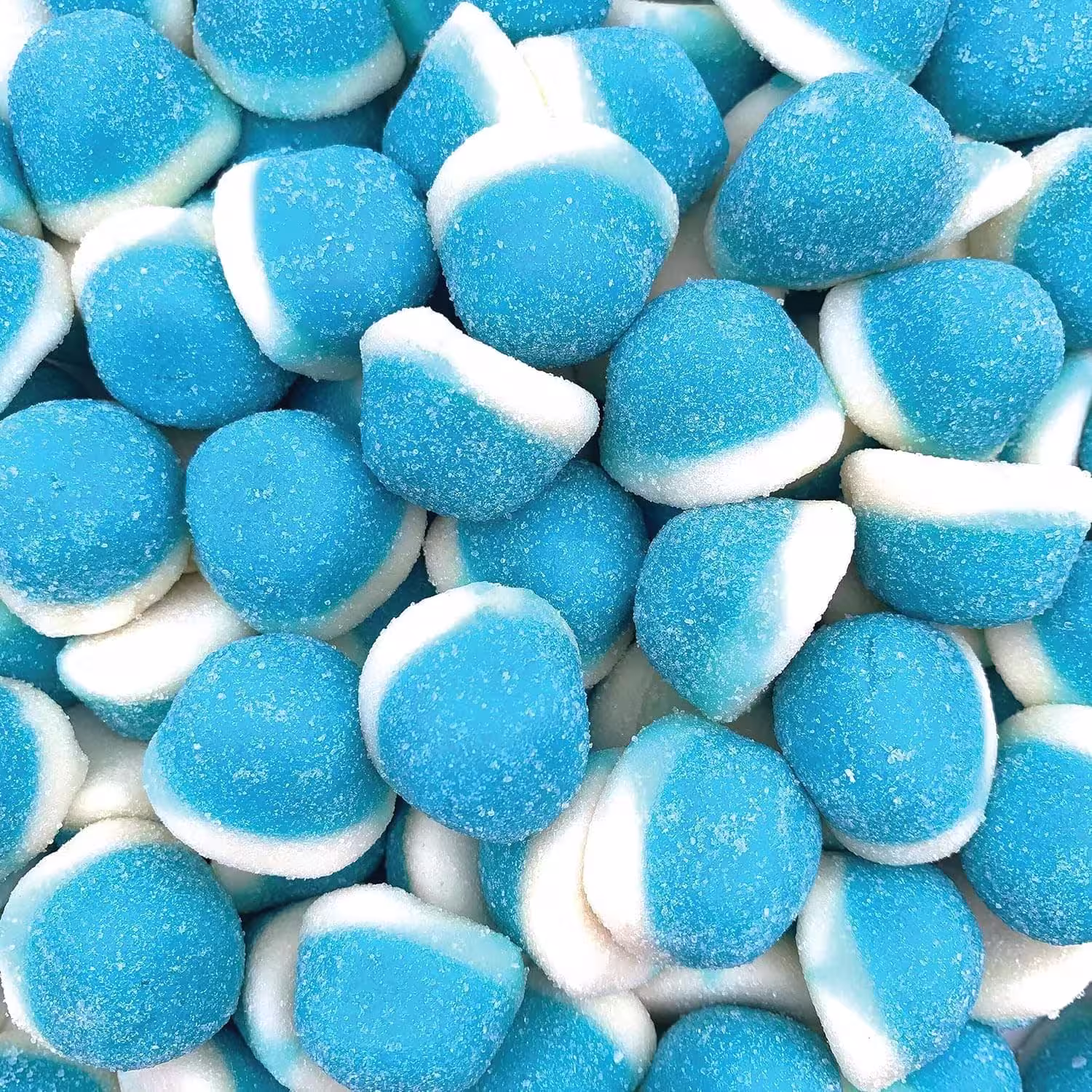 Closeup of a pile of Blue Raspberry Gummies with a fine crystal sugar coating, showcasing their vibrant blue color and chewy texture