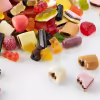 Pile of HARIBO Color Rado gummy treats featuring a colorful mix of fruit gum, licorice, and pink raspberry candies.
